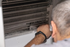 A man fixing an ice machine.